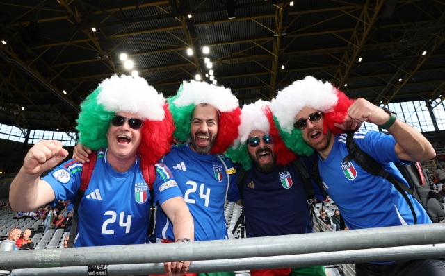 DORTMUND, GERMANY - JUNE 15: Italy fans wearing afro wigs in the colours of the flag of Italy pose for a photo prior to the UEFA EURO 2024 group stage match between Italy and Albania at Football Stadium Dortmund on June 15, 2024 in Dortmund, Germany. (Photo by Claudio Villa/Getty Images for FIGC)