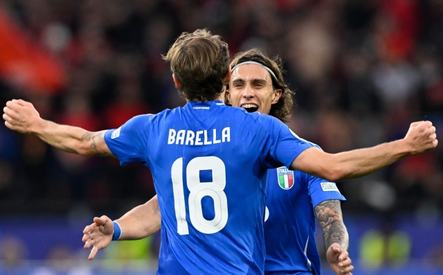 Italy's midfielder #18 Nicolo Barella celebrates with Italy's defender #05 Riccardo Calafiori after scoring his team's second goal during the UEFA Euro 2024 Group B football match between Italy and Albania at the BVB Stadion in Dortmund on June 15, 2024. (Photo by INA FASSBENDER / AFP)