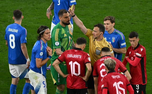 German referee Felix Zwayer gives a yellow card to Italy's defender #05 Riccardo Calafiori during the UEFA Euro 2024 Group B football match between Italy and Albania at the BVB Stadion in Dortmund on June 15, 2024. (Photo by OZAN KOSE / AFP)