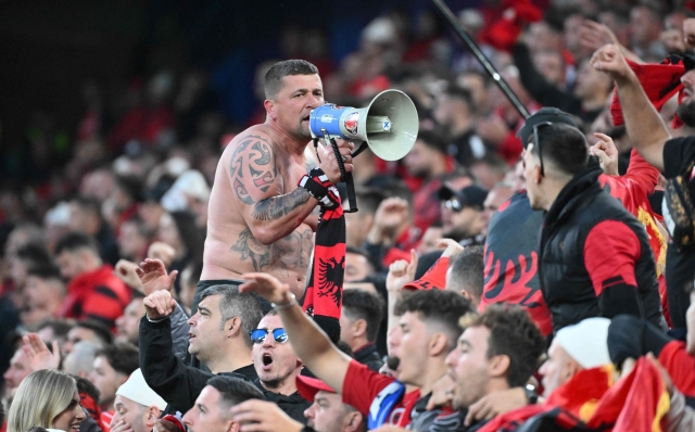 An Albany's supporter uses a megaphone during the UEFA Euro 2024 Group B football match between Italy and Albania at the BVB Stadion in Dortmund on June 15, 2024. (Photo by Alberto PIZZOLI / AFP)