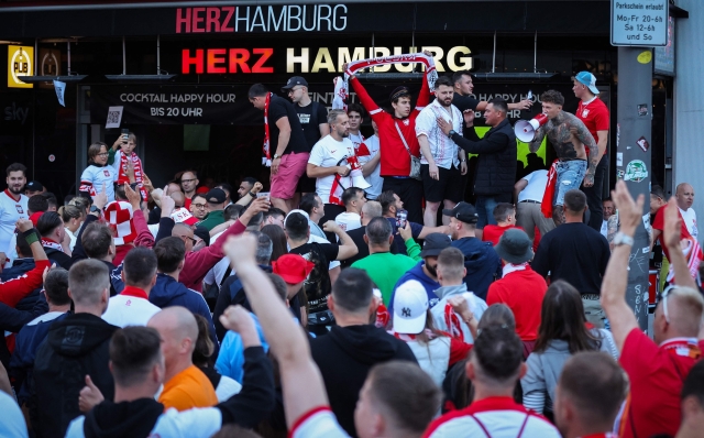 Poland's supporters gather at the famous Hamburg amusement mile "Reeperbahn" in Hamburg, northern Germany, on June 15, 2024, on the eve of the UEFA Euro 2024 football match between Poland and Netherlands. (Photo by Ronny Hartmann / AFP)