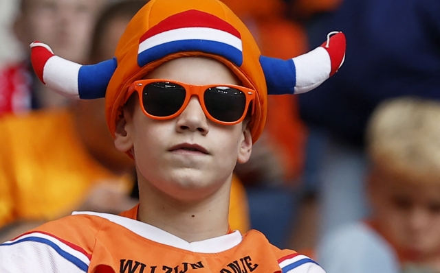 A Dutch supporter wears a hat in the color of his team prior to the UEFA Euro 2024 Group D football match between Poland and the Netherlands at the Volksparkstadion in Hamburg on June 16, 2024. (Photo by Odd ANDERSEN / AFP)