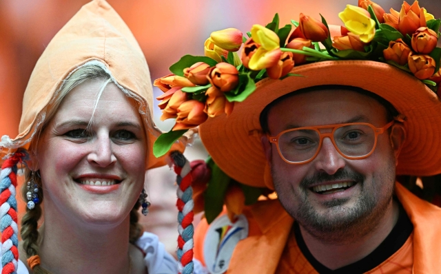 Dutch fans cheer in a tribune prior to the UEFA Euro 2024 Group D football match between Poland and the Netherlands at the Volksparkstadion in Hamburg on June 16, 2024. (Photo by GABRIEL BOUYS / AFP)