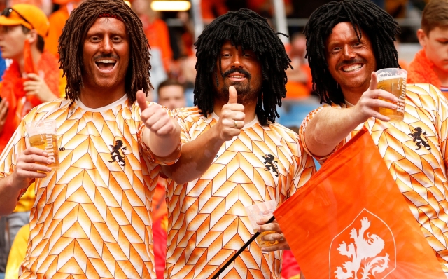 Dutch supporters gesture ahead of the UEFA Euro 2024 Group D football match between Poland and the Netherlands at the Volksparkstadion in Hamburg on June 16, 2024. (Photo by Odd ANDERSEN / AFP)
