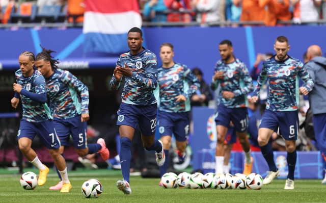 HAMBURG, GERMANY - JUNE 16: Denzel Dumfries of Netherlands applauds the fans as he takes to the field ahead of the warm up prior to the UEFA EURO 2024 group stage match between Poland and Netherlands at Volksparkstadion on June 16, 2024 in Hamburg, Germany.   (Photo by Julian Finney/Getty Images)