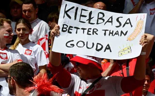 A fan of Poland holds a placard reading "Kielbasa (sausage) better than Gouda" prior to the UEFA Euro 2024 Group D football match between Poland and the Netherlands at the Volksparkstadion in Hamburg on June 16, 2024. (Photo by JOHN MACDOUGALL / AFP)