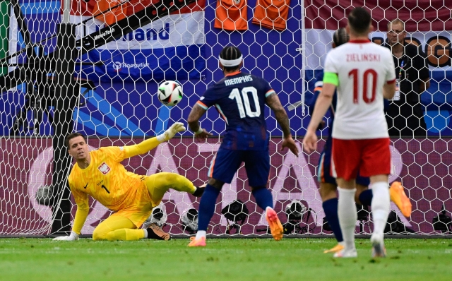 Poland's goalkeeper #01 Wojciech Szczesny (L) deflects a shot during the UEFA Euro 2024 Group D football match between Poland and the Netherlands at the Volksparkstadion in Hamburg on June 16, 2024. (Photo by JOHN MACDOUGALL / AFP)