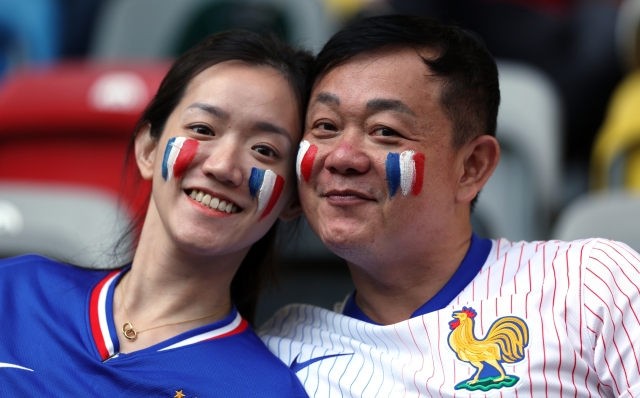 DUSSELDORF, GERMANY - JUNE 17: Fans of France wearing face paint in the colours of the national flag pose for a photo prior to the UEFA EURO 2024 group stage match between Austria and France at Düsseldorf Arena on June 17, 2024 in Dusseldorf, Germany. (Photo by Kevin C. Cox/Getty Images)