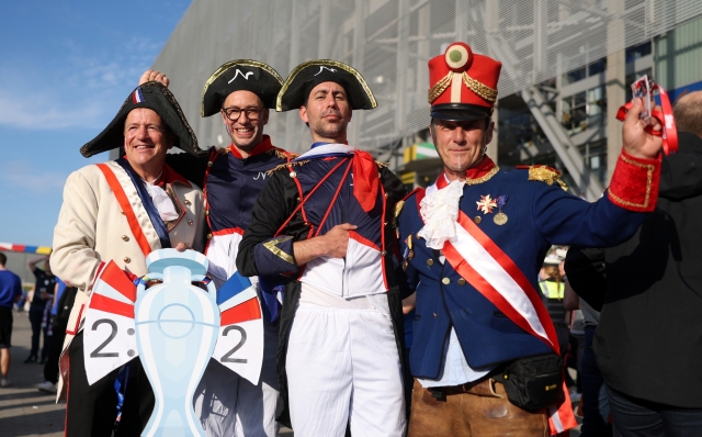 DUSSELDORF, GERMANY - JUNE 17: Fans of France, wearing fancy dress, pose for a photo on the outside of the stadium prior to the UEFA EURO 2024 group stage match between Austria and France at Düsseldorf Arena on June 17, 2024 in Dusseldorf, Germany. (Photo by Lars Baron/Getty Images)