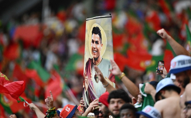 Portugal's fans hold a placard showing Portugal's forward #07 Cristiano Ronaldo prior to the UEFA Euro 2024 Group F football match between Portugal and the Czech Republic at the Leipzig Stadium in Leipzig on June 18, 2024. (Photo by Christophe SIMON / AFP)