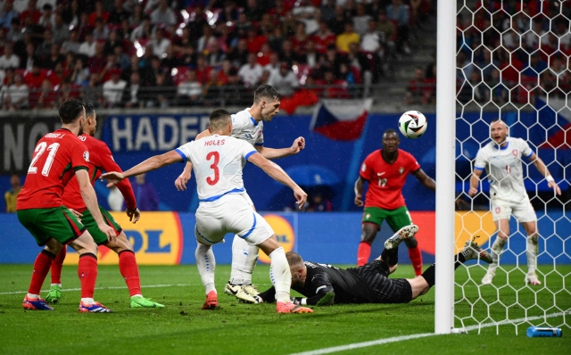 Czech Republic's defender #04 Robin Hranac (Rear C) scores a own goal during the UEFA Euro 2024 Group F football match between Portugal and the Czech Republic at the Leipzig Stadium in Leipzig on June 18, 2024. (Photo by Christophe SIMON / AFP)