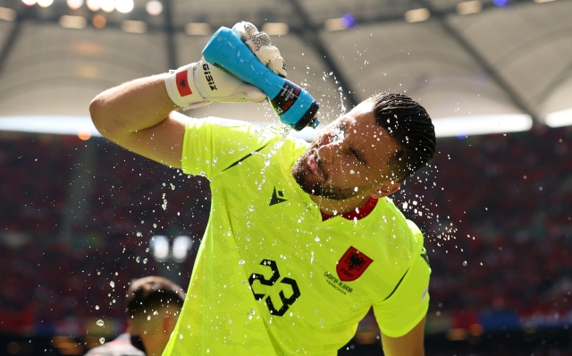 HAMBURG, GERMANY - JUNE 19: Thomas Strakosha of Albania sprays a bottle of water into his mouth as he pauses for a drink prior to the UEFA EURO 2024 group stage match between Croatia and Albania at Volksparkstadion on June 19, 2024 in Hamburg, Germany. (Photo by Julian Finney/Getty Images)