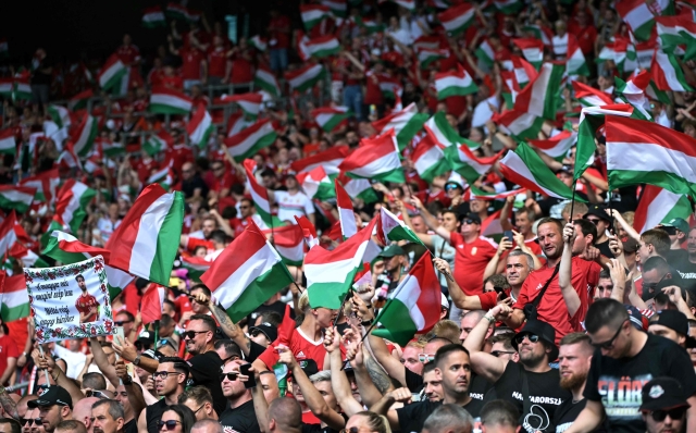 Hungary supporters wave flags prior to the UEFA Euro 2024 Group A football match between Germany and Hungary at the Stuttgart Arena in Stuttgart on June 19, 2024. (Photo by DAMIEN MEYER / AFP)