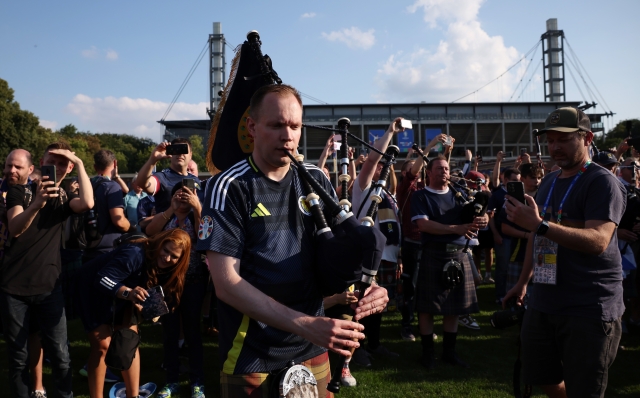 COLOGNE, GERMANY - JUNE 19: Fans of Scotland play the bagpipes as they arrive outside the stadium prior to the UEFA EURO 2024 group stage match between Scotland and Switzerland at Cologne Stadium on June 19, 2024 in Cologne, Germany. (Photo by Alex Grimm/Getty Images)