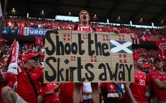 A Switzerland fan displays a banner mocking the Scots, in the crowd ahead of the UEFA Euro 2024 Group A football match between Scotland and Switzerland at the Cologne Stadium in Cologne on June 19, 2024. (Photo by Angelos TZORTZINIS / AFP)