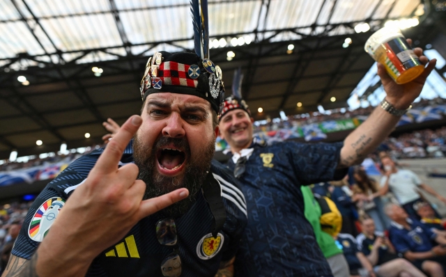 A Scotland fan gestures in the crowd ahead of the UEFA Euro 2024 Group A football match between Scotland and Switzerland at the Cologne Stadium in Cologne on June 19, 2024. (Photo by OZAN KOSE / AFP)