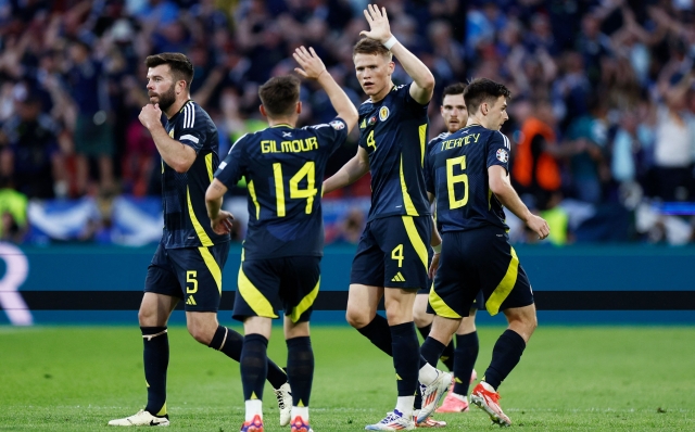 Scotland's players celebrate the first goal the UEFA Euro 2024 Group A football match between Scotland and Switzerland at the Cologne Stadium in Cologne on June 19, 2024. (Photo by KENZO TRIBOUILLARD / AFP)