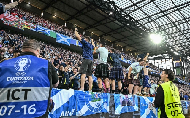 Scottish supporters gesture during the UEFA Euro 2024 Group A football match between Scotland and Switzerland at the Cologne Stadium in Cologne on June 19, 2024. (Photo by JAVIER SORIANO / AFP)