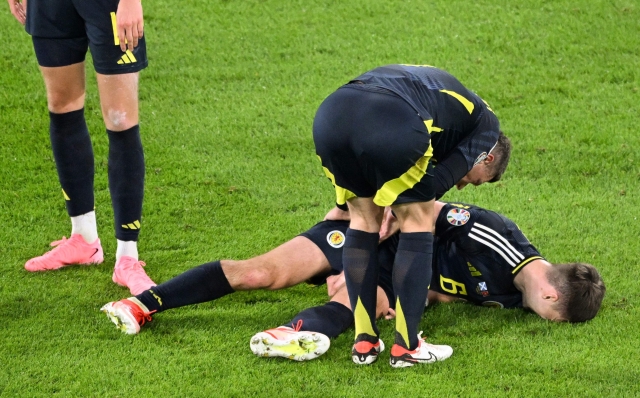 Scotland's defender #06 Kieran Tierney lies on the pitch after being injured during the UEFA Euro 2024 Group A football match between Scotland and Switzerland at the Cologne Stadium in Cologne on June 19, 2024. (Photo by Kirill KUDRYAVTSEV / AFP)
