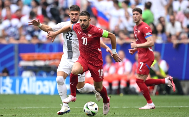 MUNICH, GERMANY - JUNE 20: Dusan Tadic of Serbia runs with the ball whilst under pressure from Adam Gnezda Cerin of Slovenia  during the UEFA EURO 2024 group stage match between Slovenia and Serbia at Munich Football Arena on June 20, 2024 in Munich, Germany. (Photo by Clive Mason/Getty Images)