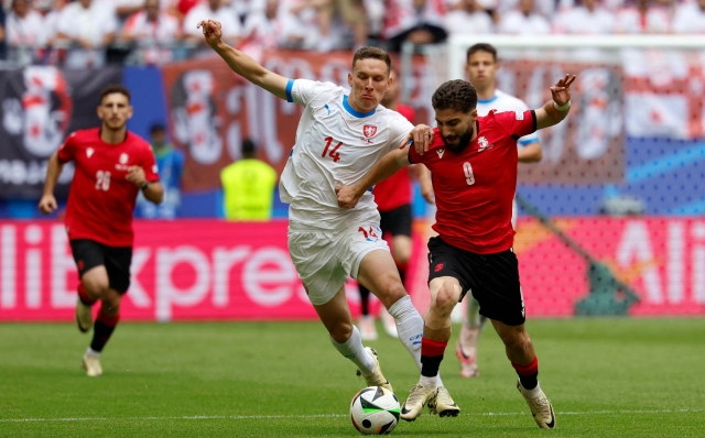 (From L) Czech Republic's midfielder #14 Lukas Provod and Georgia's midfielder #09 Zuriko Davitashvili fight for the ball during the UEFA Euro 2024 Group F football match between Georgia and the Czech Republic at the Volksparkstadion in Hamburg on June 22, 2024. (Photo by AXEL HEIMKEN / AFP)