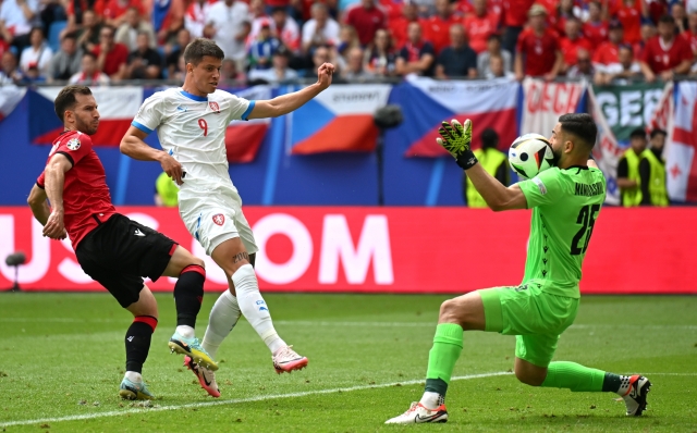 HAMBURG, GERMANY - JUNE 22: Adam Hlozek of Czechia takes a shot which is saved by Giorgi Mamardashvili of Georgia before scoring a goal which is later disallowed for handball following a VAR review during the UEFA EURO 2024 group stage match between Georgia and Czechia at Volksparkstadion on June 22, 2024 in Hamburg, Germany. (Photo by Dan Mullan/Getty Images)