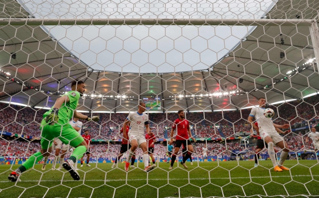 Czech Republic's forward #10 Patrik Schick (R) kicks the ball to score his team's first goal next to Georgia's goalkeeper #25 Giorgi Mamardashvili (L) during the UEFA Euro 2024 Group F football match between Georgia and the Czech Republic at the Volksparkstadion in Hamburg on June 22, 2024. (Photo by Ronny HARTMANN / AFP)