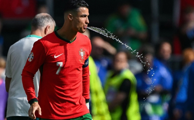 Portugal's forward #07 Cristiano Ronaldo spits out water ahead of the UEFA Euro 2024 Group F football match between Turkey and Portugal at the BVB Stadion in Dortmund on June 22, 2024. (Photo by OZAN KOSE / AFP)