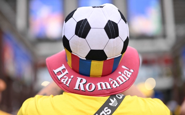 A Romania's supporter arrives before the start of the UEFA Euro 2024 Group E football match between Belgium and Romania at the Cologne Stadium in Cologne on June 22, 2024. (Photo by Kirill KUDRYAVTSEV / AFP)