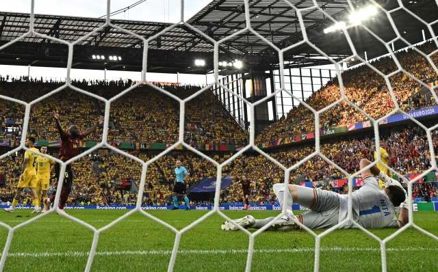 Belgium's forward #10 Romelu Lukaku (L) celebrates after Belgium's midfielder #08 Youri Tielemans scored the opening goal past Romania's goalkeeper #01 Florin Nita during the UEFA Euro 2024 Group E football match between Belgium and Romania at the Cologne Stadium in Cologne on June 22, 2024. (Photo by JAVIER SORIANO / AFP)