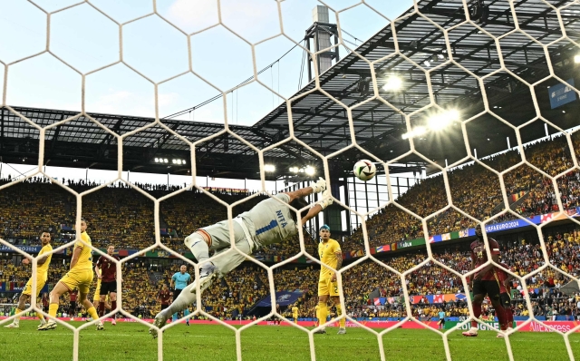Romania's goalkeeper #01 Florin Nita makes a save during the UEFA Euro 2024 Group E football match between Belgium and Romania at the Cologne Stadium in Cologne on June 22, 2024. (Photo by JAVIER SORIANO / AFP)