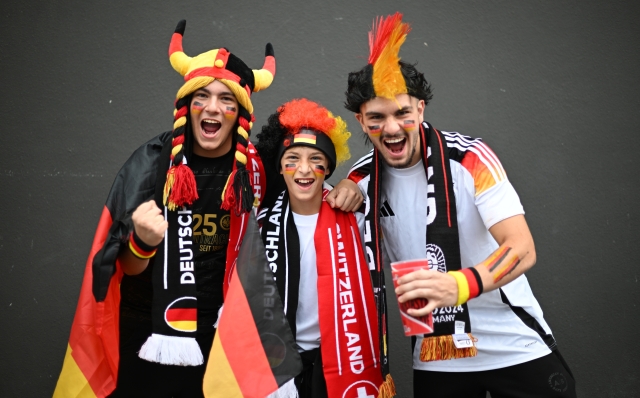 FRANKFURT AM MAIN, GERMANY - JUNE 23: Fans of Germany pose for a photo while wearing face paint in the colours of the National Team flag prior to the UEFA EURO 2024 group stage match between Switzerland and Germany at Frankfurt Arena on June 23, 2024 in Frankfurt am Main, Germany. (Photo by Justin Setterfield/Getty Images)