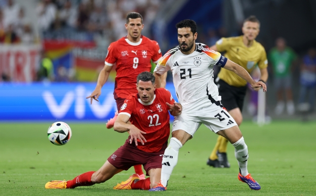 FRANKFURT AM MAIN, GERMANY - JUNE 23: Fabian Schaer of Switzerland is challenged by Ilkay Guendogan of Germany during the UEFA EURO 2024 group stage match between Switzerland and Germany at Frankfurt Arena on June 23, 2024 in Frankfurt am Main, Germany. (Photo by Lars Baron/Getty Images)