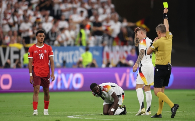 FRANKFURT AM MAIN, GERMANY - JUNE 23: Dan Ndoye of Switzerland receives a yellow card from Referee Daniele Orsato during the UEFA EURO 2024 group stage match between Switzerland and Germany at Frankfurt Arena on June 23, 2024 in Frankfurt am Main, Germany. (Photo by Alex Grimm/Getty Images)