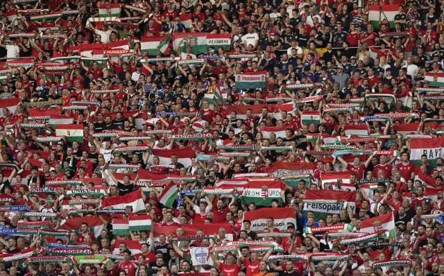 Hungary's fans show scarves and flags during the national anthem before a Group A match between Scotland and Hungary at the Euro 2024 soccer tournament in Stuttgart, Germany, Sunday, June 23, 2024. (AP Photo/Antonio Calanni)