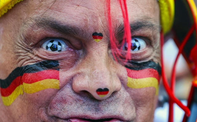 epa11432980 Supporter of Germany cheers during the public screening of the UEFA EURO 2024 match Germany vs Switzerland in Berlin, Germany, 23 June 2024.  EPA/HANNIBAL HANSCHKE