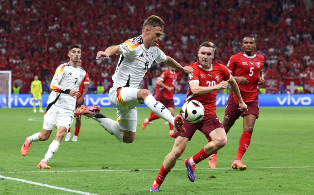 FRANKFURT AM MAIN, GERMANY - JUNE 23: Joshua Kimmich of Germany controls the ball whilst under pressure from Michel Aebischer of Switzerland during the UEFA EURO 2024 group stage match between Switzerland and Germany at Frankfurt Arena on June 23, 2024 in Frankfurt am Main, Germany. (Photo by Alexander Hassenstein/Getty Images)