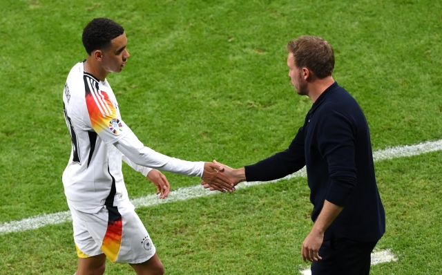 FRANKFURT AM MAIN, GERMANY - JUNE 23: Jamal Musiala of Germany interacts with Julian Nagelsmann, Head Coach of Germany, as he is substituted during the UEFA EURO 2024 group stage match between Switzerland and Germany at Frankfurt Arena on June 23, 2024 in Frankfurt am Main, Germany. (Photo by Justin Setterfield/Getty Images)