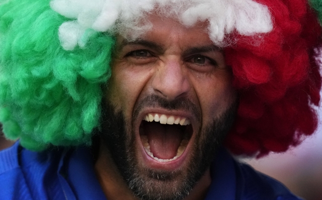 An Italian fan celebrates prior to a Group B match between Croatia and Italy at the Euro 2024 soccer tournament in Leipzig, Germany, Monday, June 24, 2024. (AP Photo/Petr David Josek)