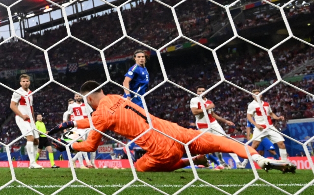 Croatia's goalkeeper #01 Dominik Livakovic makes a save during the UEFA Euro 2024 Group B football match between the Croatia and Italy at the Leipzig Stadium in Leipzig on June 24, 2024. (Photo by Christophe Simon / AFP)