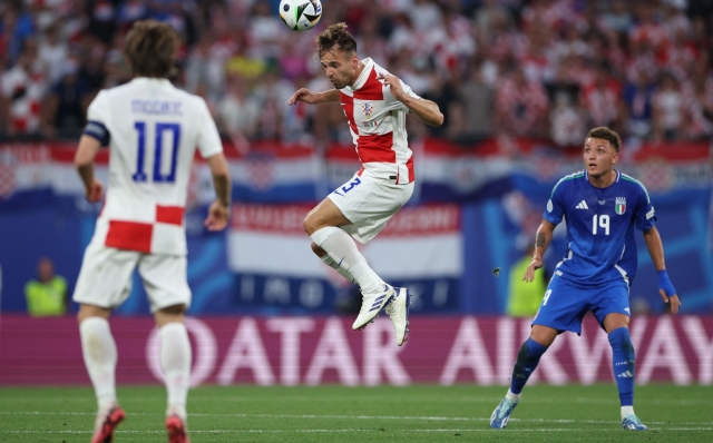 TOPSHOT - Croatia's defender #03 Marin Pongracic heads the ball during the UEFA Euro 2024 Group B football match between the Croatia and Italy at the Leipzig Stadium in Leipzig on June 24, 2024. (Photo by Ronny HARTMANN / AFP)