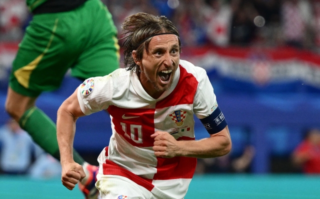 Croatia's midfielder #10 Luka Modric celebrates scoring his team's first goal during the UEFA Euro 2024 Group B football match between the Croatia and Italy at the Leipzig Stadium in Leipzig on June 24, 2024. (Photo by Christophe SIMON / AFP)