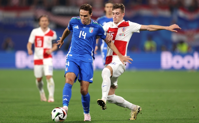 LEIPZIG, GERMANY - JUNE 24: Federico Chiesa of Italy is challenged by Mario Pasalic of Croatia during the UEFA EURO 2024 group stage match between Croatia and Italy at Football Stadium Leipzig on June 24, 2024 in Leipzig, Germany. (Photo by Julian Finney/Getty Images)