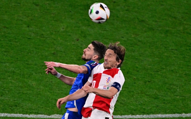 (From L) Italy's defender #06 Federico Gatti and Croatia's midfielder #10 Luka Modric fight for the ball during the UEFA Euro 2024 Group B football match between Croatia and Italy at the Leipzig Stadium in Leipzig on June 24, 2024. (Photo by JOHN MACDOUGALL / AFP)
