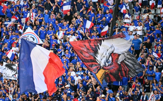 France's supporters waves flags ahead of the UEFA Euro 2024 Group D football match between France and Poland at the BVB Stadion in Dortmund on June 25, 2024. (Photo by Alberto PIZZOLI / AFP)