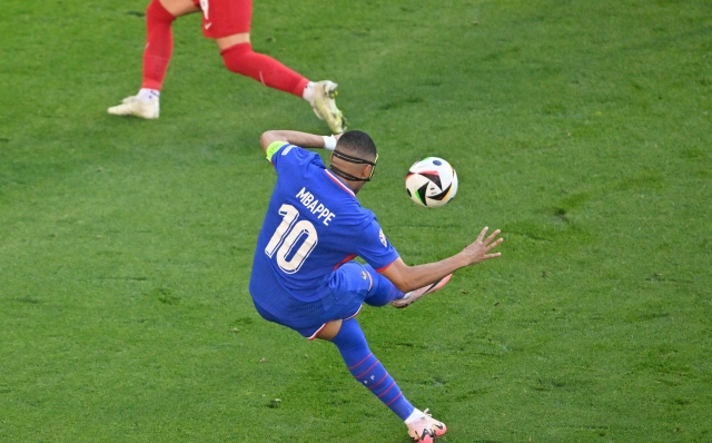 France's forward #10 Kylian Mbappe shoots the ball but misses an attempt to score during to the UEFA Euro 2024 Group D football match between France and Poland at the BVB Stadion in Dortmund on June 25, 2024. (Photo by INA FASSBENDER / AFP)