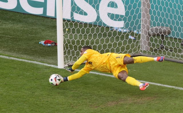 DORTMUND, GERMANY - JUNE 25: Brice Samba of France saves a penalty kick from Robert Lewandowski of Poland, which is later retaken due to an infringement, during the UEFA EURO 2024 group stage match between France and Poland at Football Stadium Dortmund on June 25, 2024 in Dortmund, Germany. (Photo by Lars Baron/Getty Images)