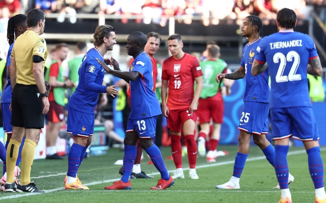 France's forward #25 Bradley Barcola (2R) and France's midfielder #13 N'Golo Kante (C) greet France's midfielder #07 Antoine Griezmann (2L) as they are being substituted during the UEFA Euro 2024 Group D football match between France and Poland at the BVB Stadion in Dortmund on June 25, 2024. (Photo by FRANCK FIFE / AFP)