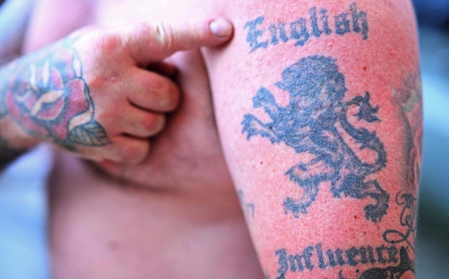 An English supporter shows his tattoo before the UEFA Euro 2024 Group C football match between England and Slovenia at the Cologne Stadium in Cologne on June 25, 2024. (Photo by Kirill KUDRYAVTSEV / AFP)