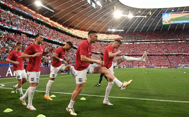 (From L) Serbia's forward #14 Andrija Zivkovic, Serbia's midfielder #19 Lazar Samardzic, Serbia's midfielder #06 Nemanja Gudelj and Serbia's defender #13 Milos Veljkovic warms up ahead of the UEFA Euro 2024 Group C football match between Denmark and Serbia at the Munich Football Arena in Munich on June 25, 2024. (Photo by Thomas KIENZLE / AFP)